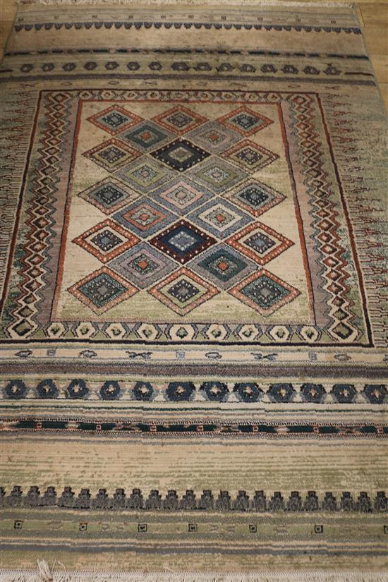 A Marks and Spencers Eastern rug, the centre field with lozenge devices